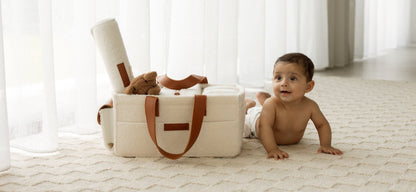Baby crawling next to a pocketed caddy