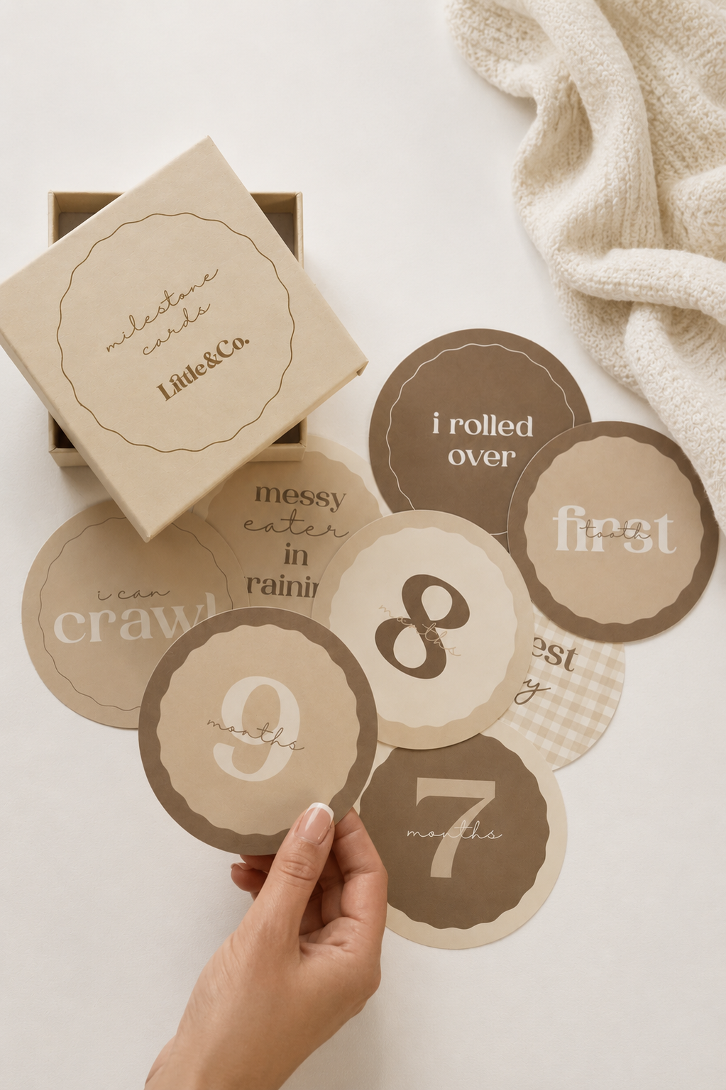 Baby milestone cards with text and a box labeled 'Little & Co' on a light background.