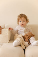 toddler with lamb and teddy cuddly in her lap