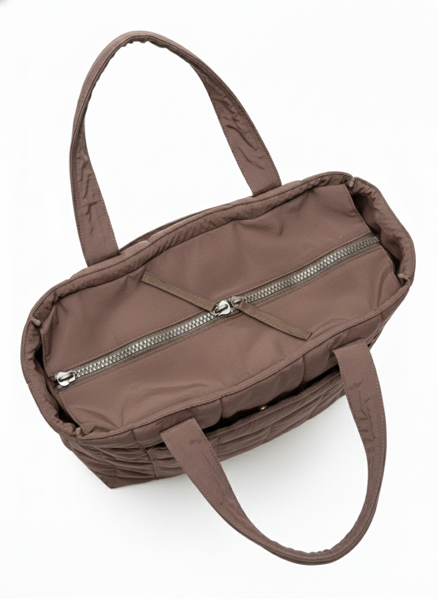 Brown handbag with a zipper on a white background