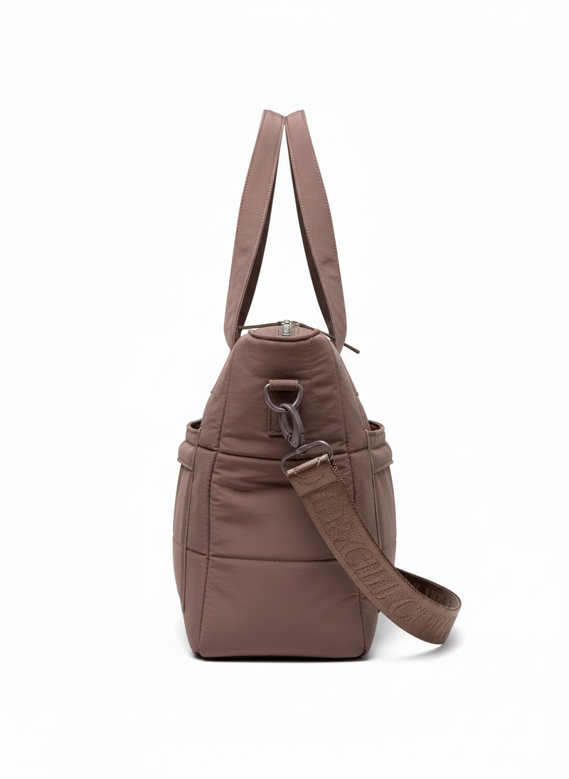Brown nappy bag with a strap on a white background